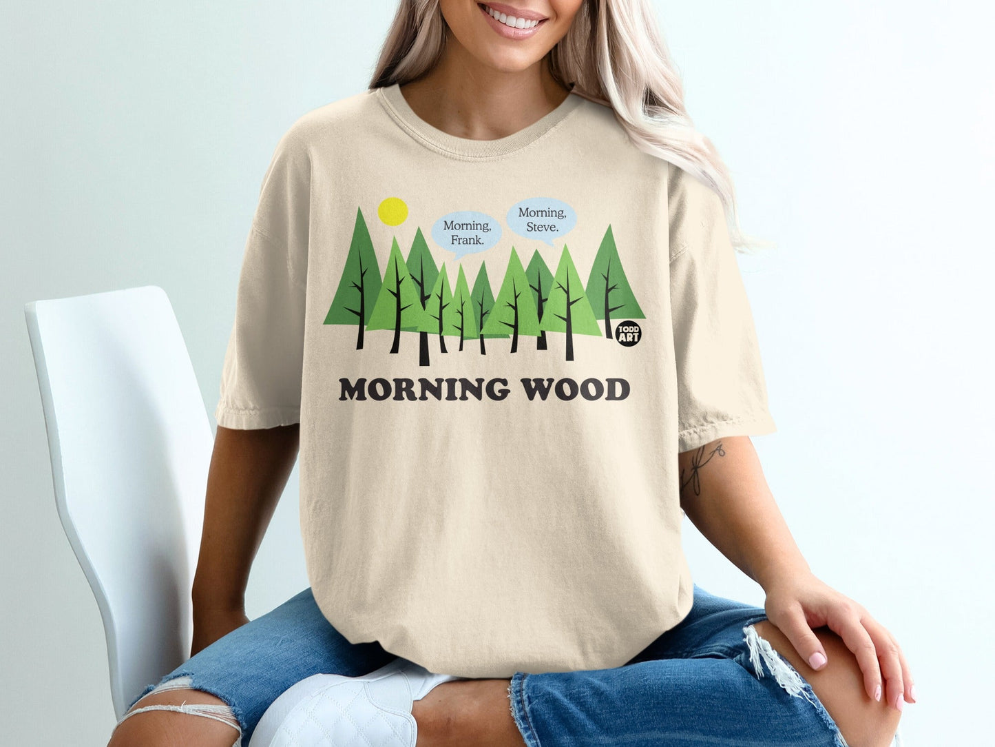 Beige t-shirt with cartoon trees and text "Morning Wood."