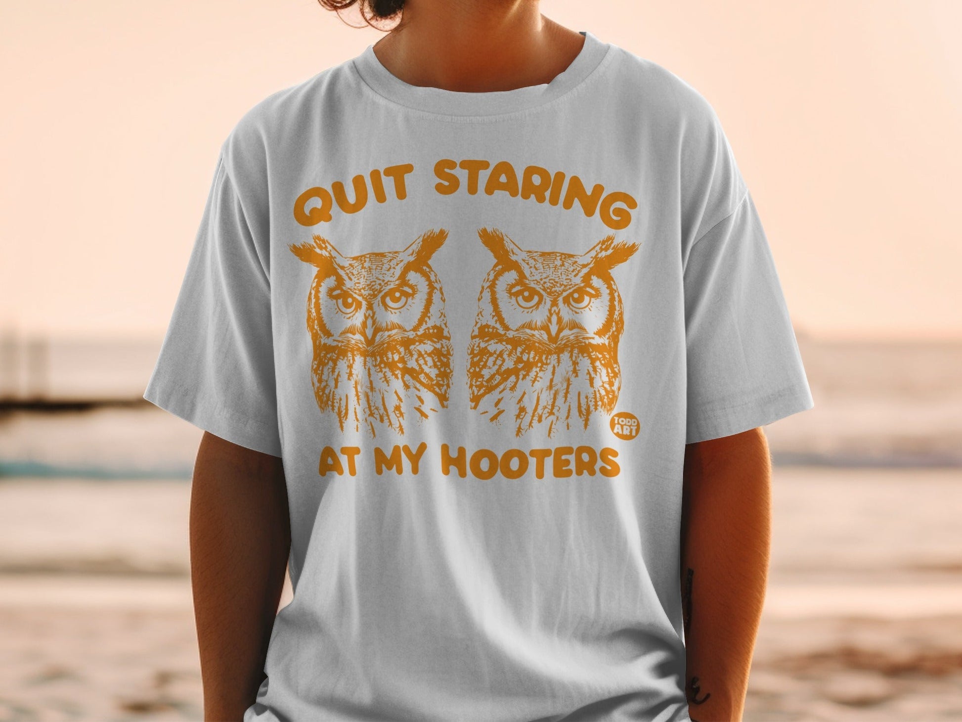 White t-shirt with "Quit Staring At My Hooters" and two owl graphics.