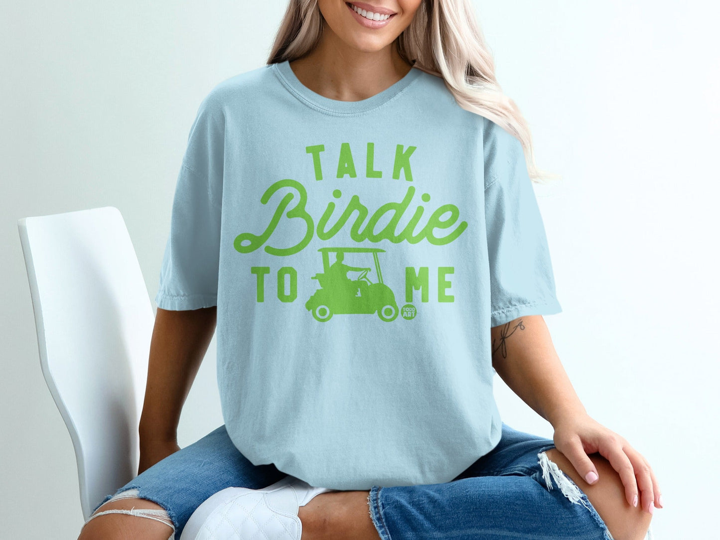 Light blue t-shirt with "TALK Birdie TO ME" graphic and golf cart.