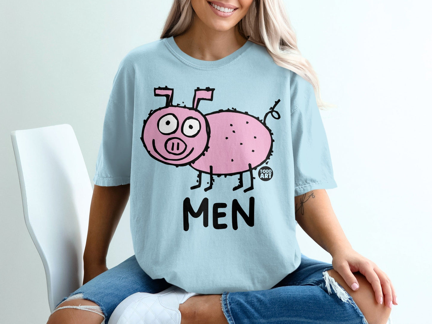 Light blue t-shirt with cartoon pink pig and "MEN" text.