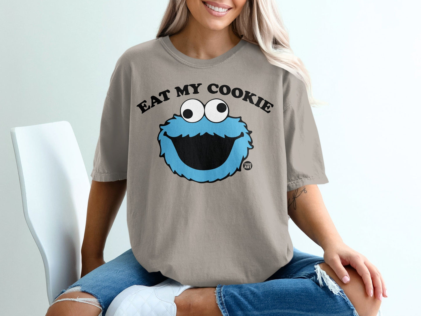 Cookie Monster graphic on tan t-shirt with text "Eat My Cookie".