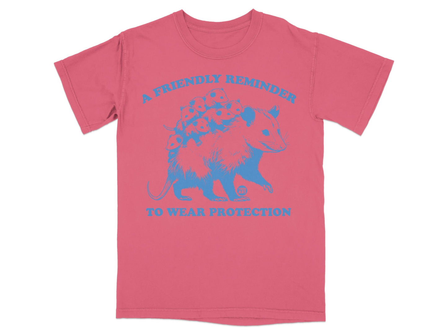 Pink t-shirt with blue graphic of an opossum and text "A FRIENDLY REMINDER TO WEAR PROTECTION".