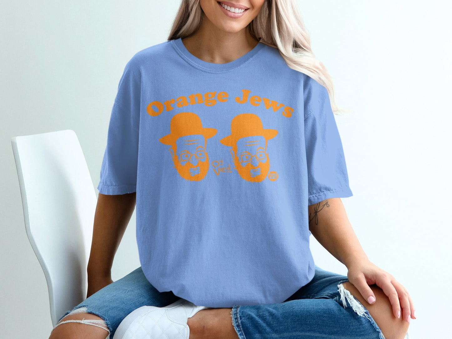 Blue t-shirt with orange text "Orange Jews" and cartoon faces.