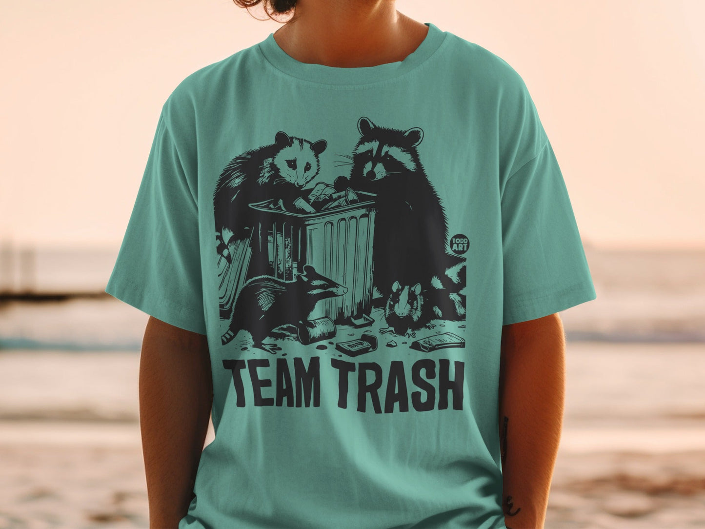 Raccoon and opossum crew digging through trash bin, "TEAM TRASH" text.