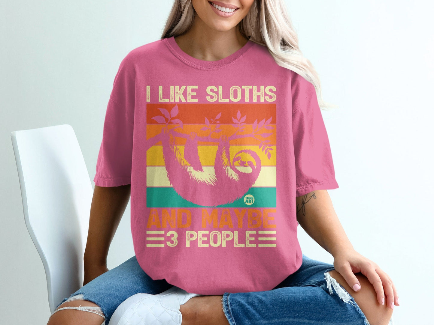 Pink t-shirt with "I like sloths and maybe 3 people" text and sloth graphic.