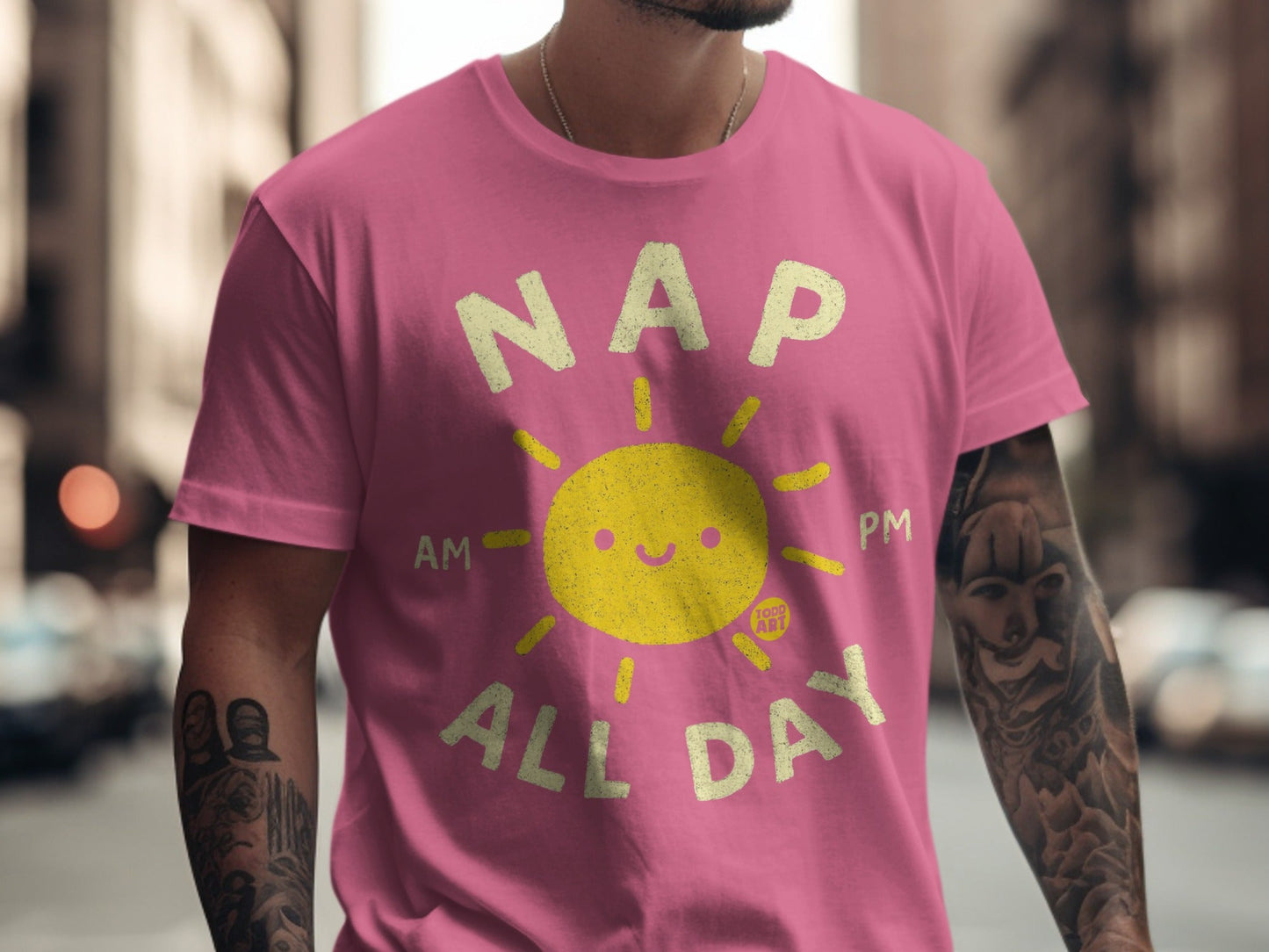 Pink t-shirt with "NAP ALL DAY" and smiling sun graphic.