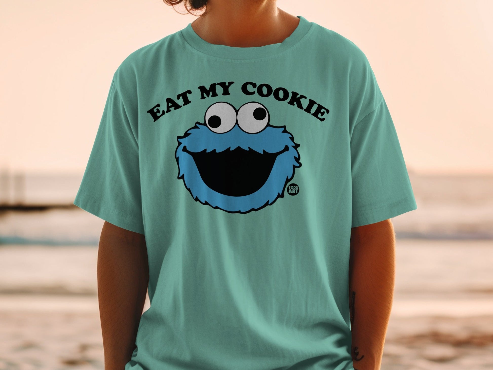 Teal t-shirt with Cookie Monster's face and "Eat My Cookie" text.
