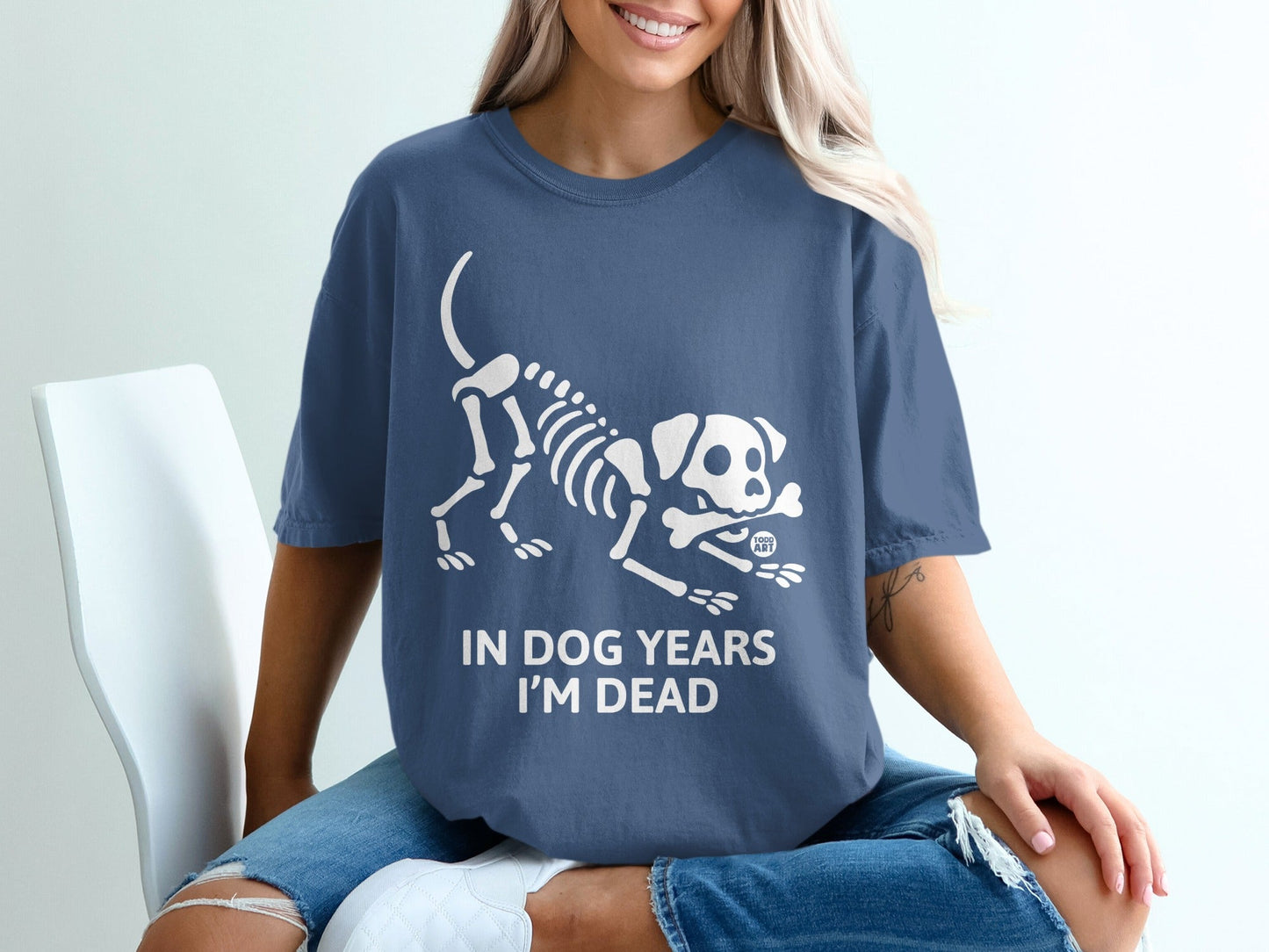 Blue t-shirt with white dog skeleton graphic and text "IN DOG YEARS I'M DEAD".