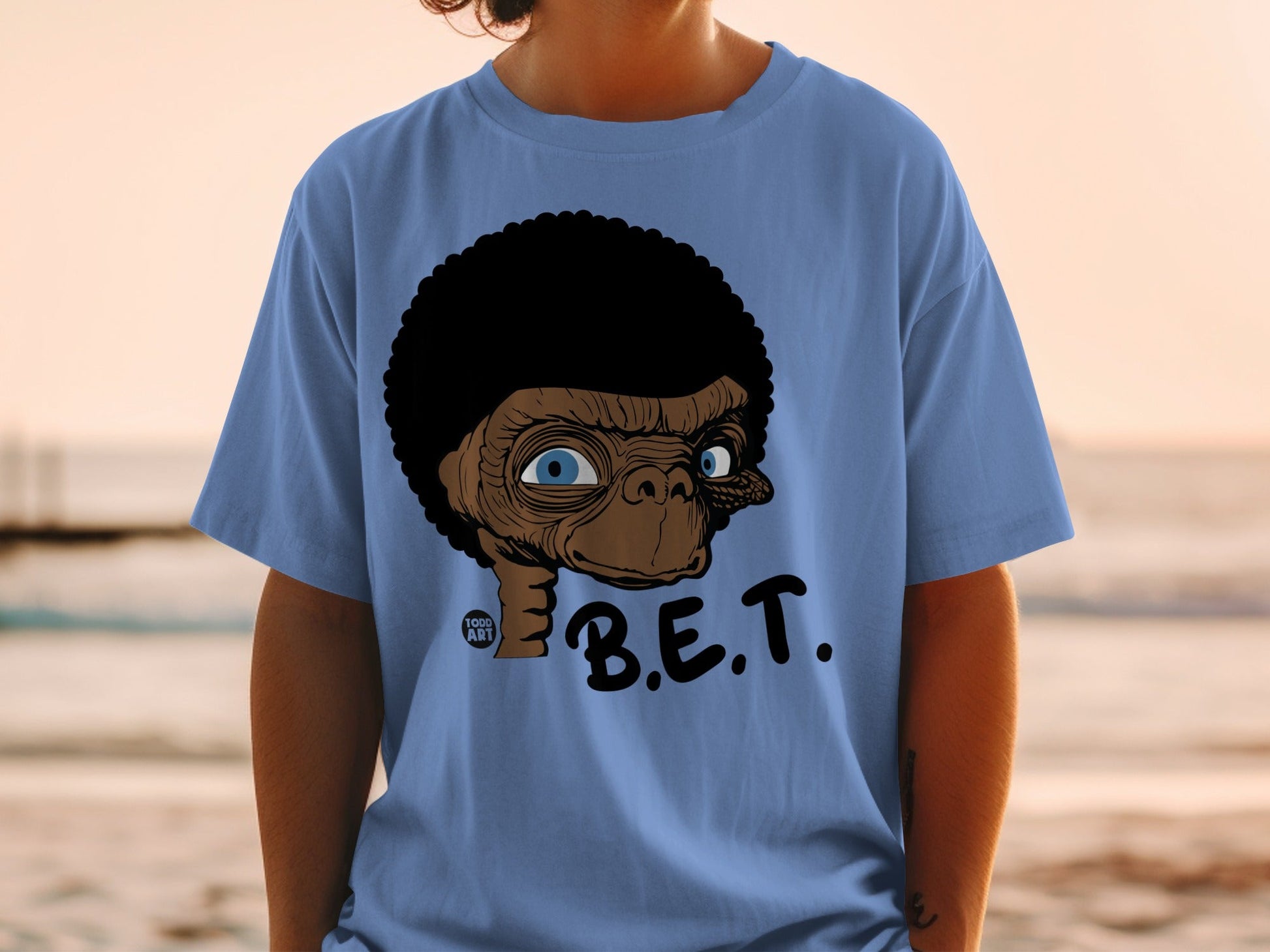 Blue t-shirt with an illustration of E.T. with an afro and the text "B.E.T."