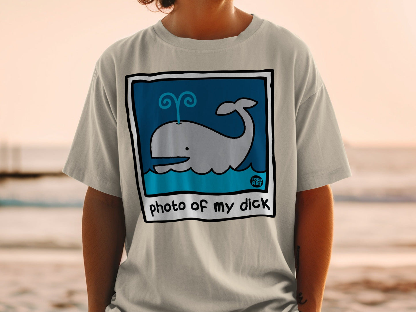 Light gray t-shirt with cartoon whale in blue square and text "photo of my dick".