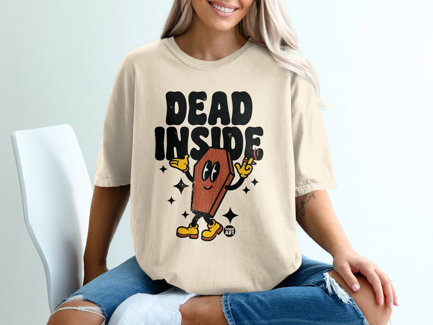T-shirt with "DEAD INSIDE" text and cartoon coffin character.