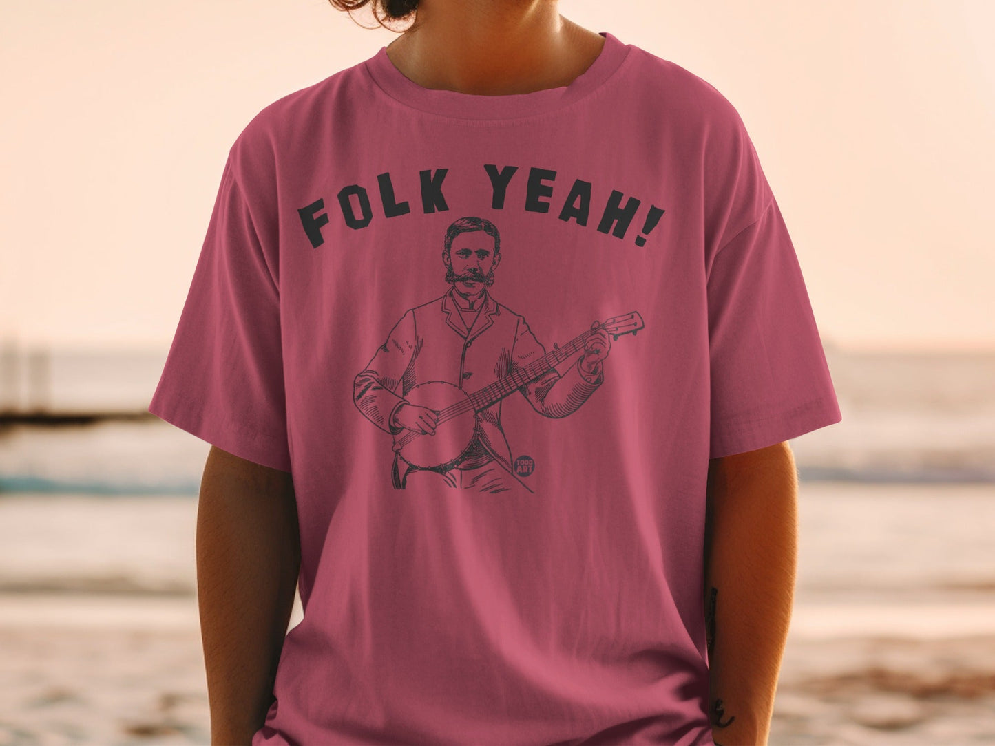 T-shirt with black text "Folk Yeah!" and a line drawing of a man playing a banjo.