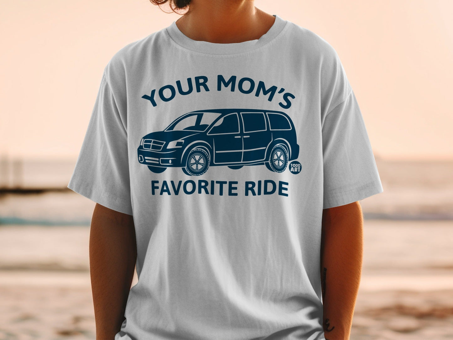 White t-shirt with "YOUR MOM'S FAVORITE RIDE" and a minivan graphic.
