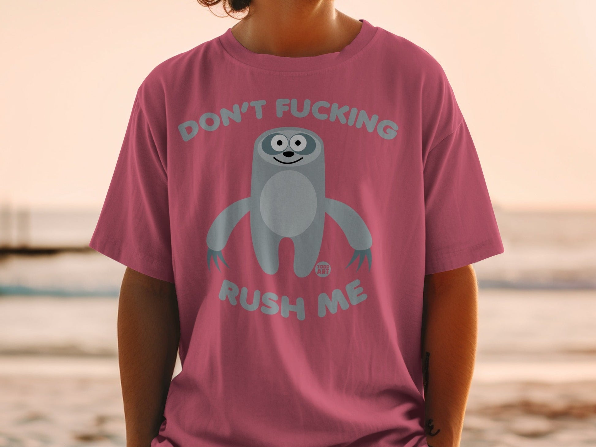 Pink t-shirt with cartoon sloth and "Don't fucking rush me" text.