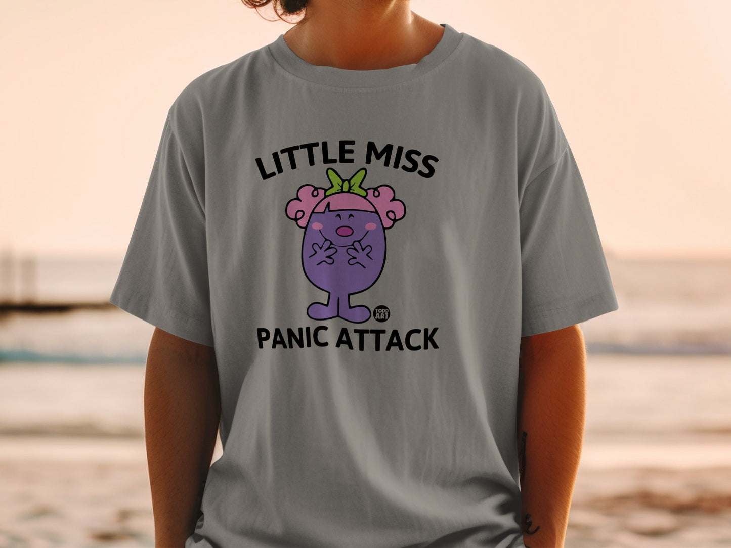 Little Miss Panic Attack t-shirt with purple character and text.