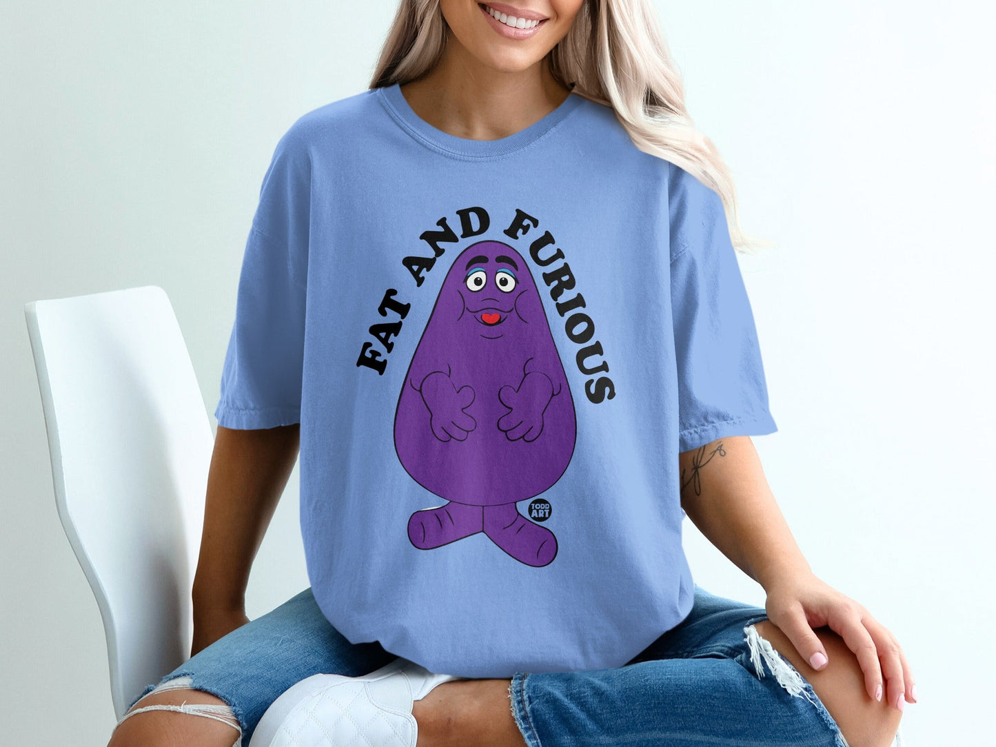 Purple character with "FAT AND FURIOUS" text on a light blue t-shirt.