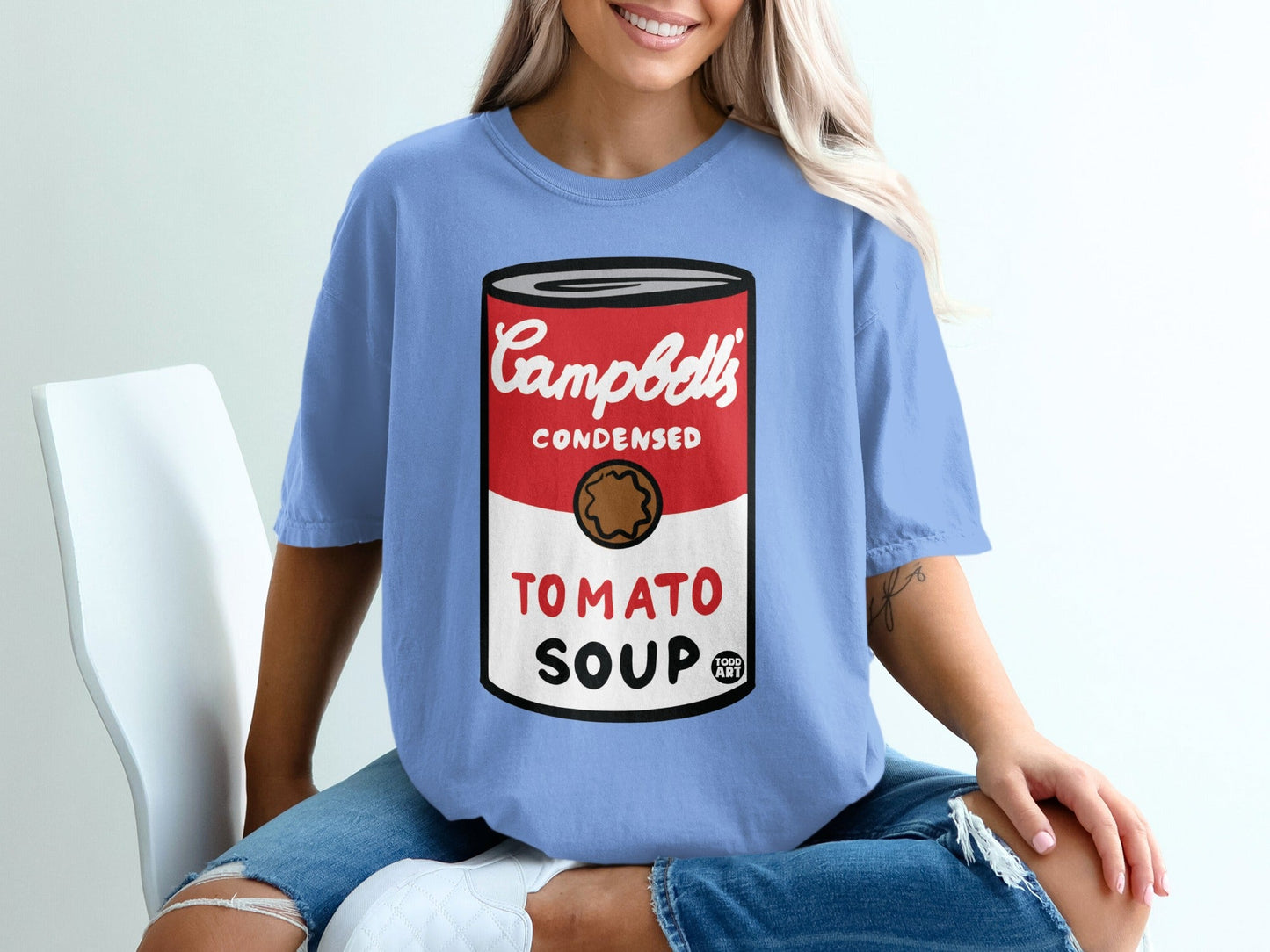 Light blue t-shirt with Campbell's Condensed Tomato Soup can graphic.