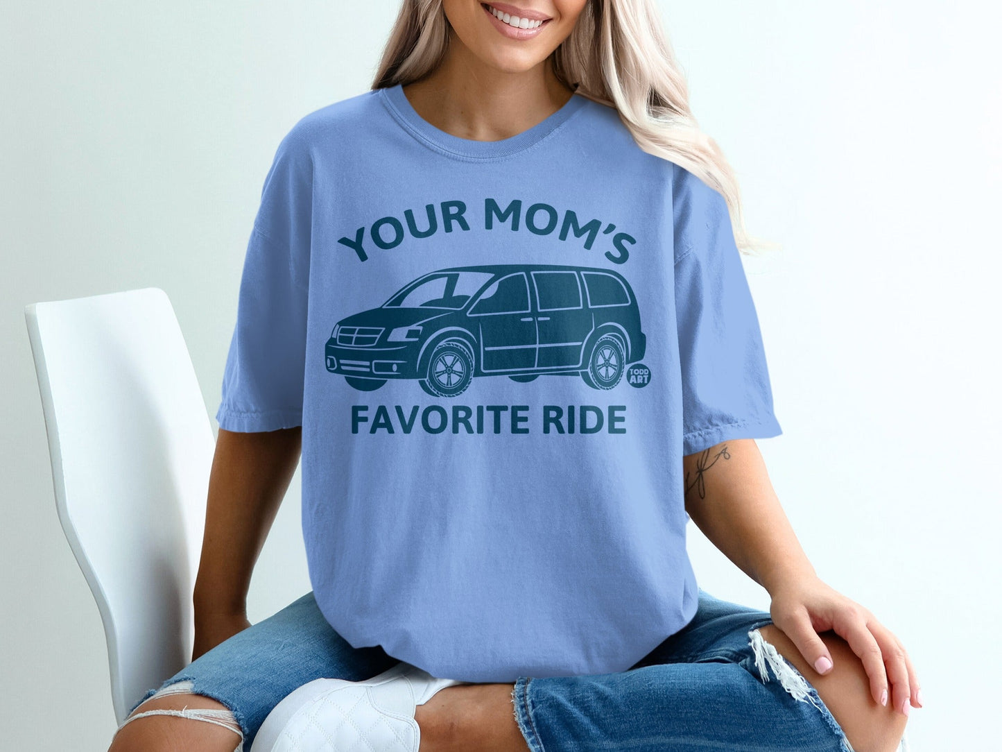 Blue t-shirt with a graphic of a van and text "YOUR MOM'S FAVORITE RIDE".