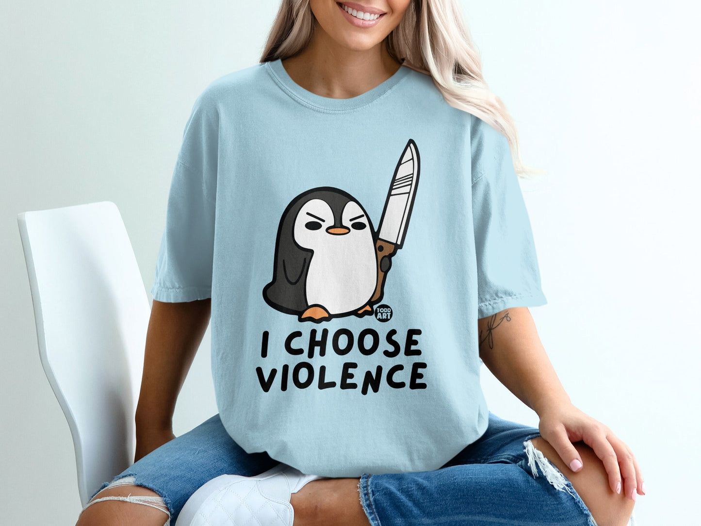 Light blue t-shirt with a cartoon penguin holding a knife and the text "I CHOOSE VIOLENCE."