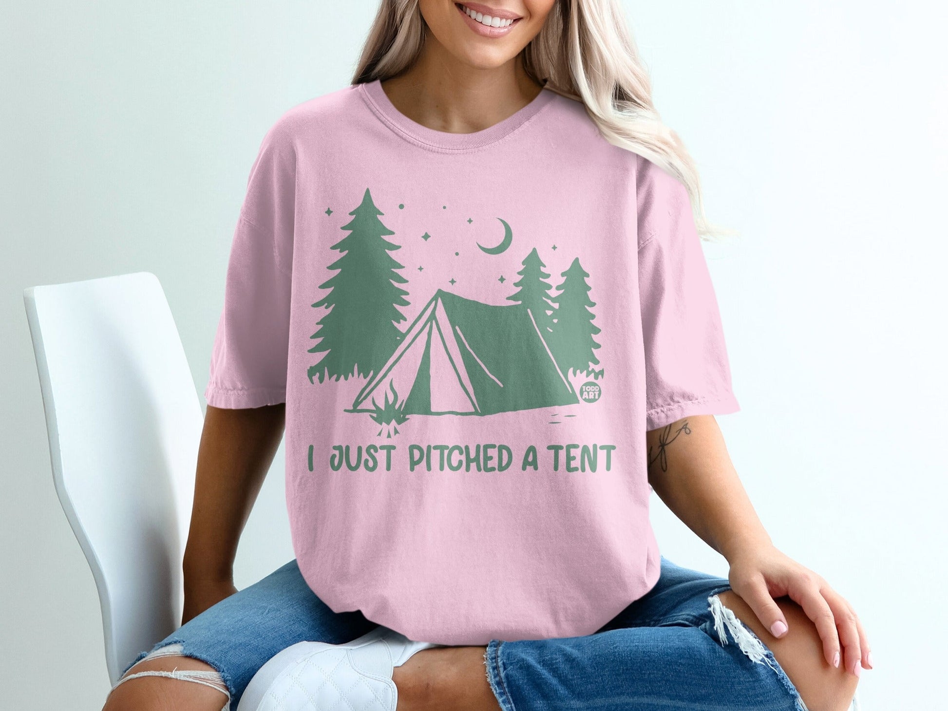 Pink t-shirt with tent, trees, and moon graphic and "I JUST PITCHED A TENT" text.
