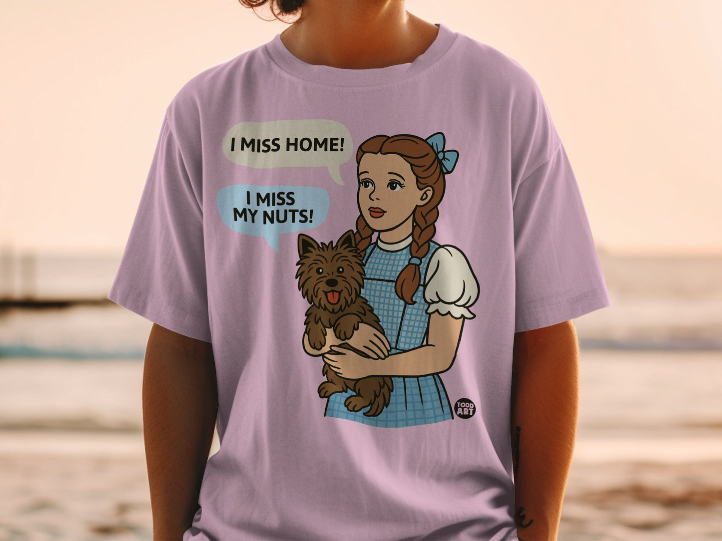 Dorothy from Wizard of Oz holding Toto, saying "I miss home!"