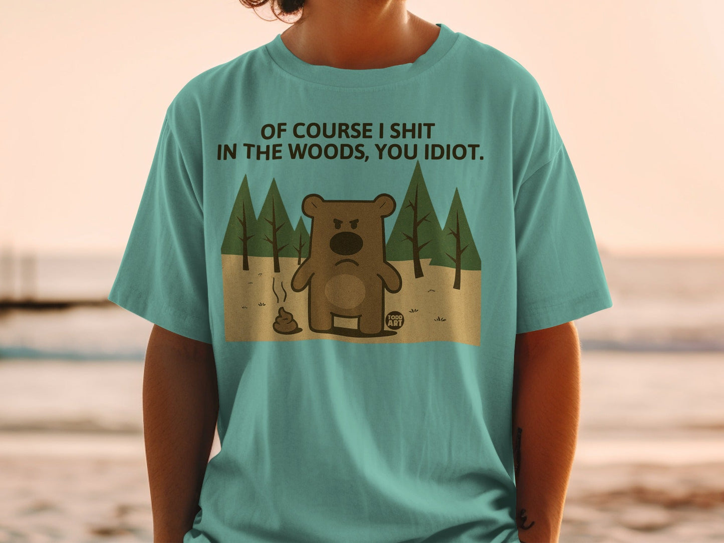 Teal t-shirt with angry bear graphic and text "Of course I shit in the woods, you idiot."
