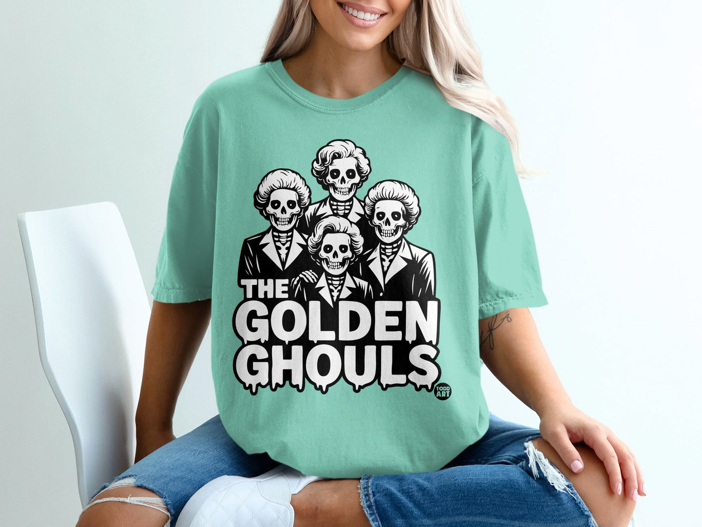 T-shirt with skeletons in suits and "The Golden Ghouls" text.