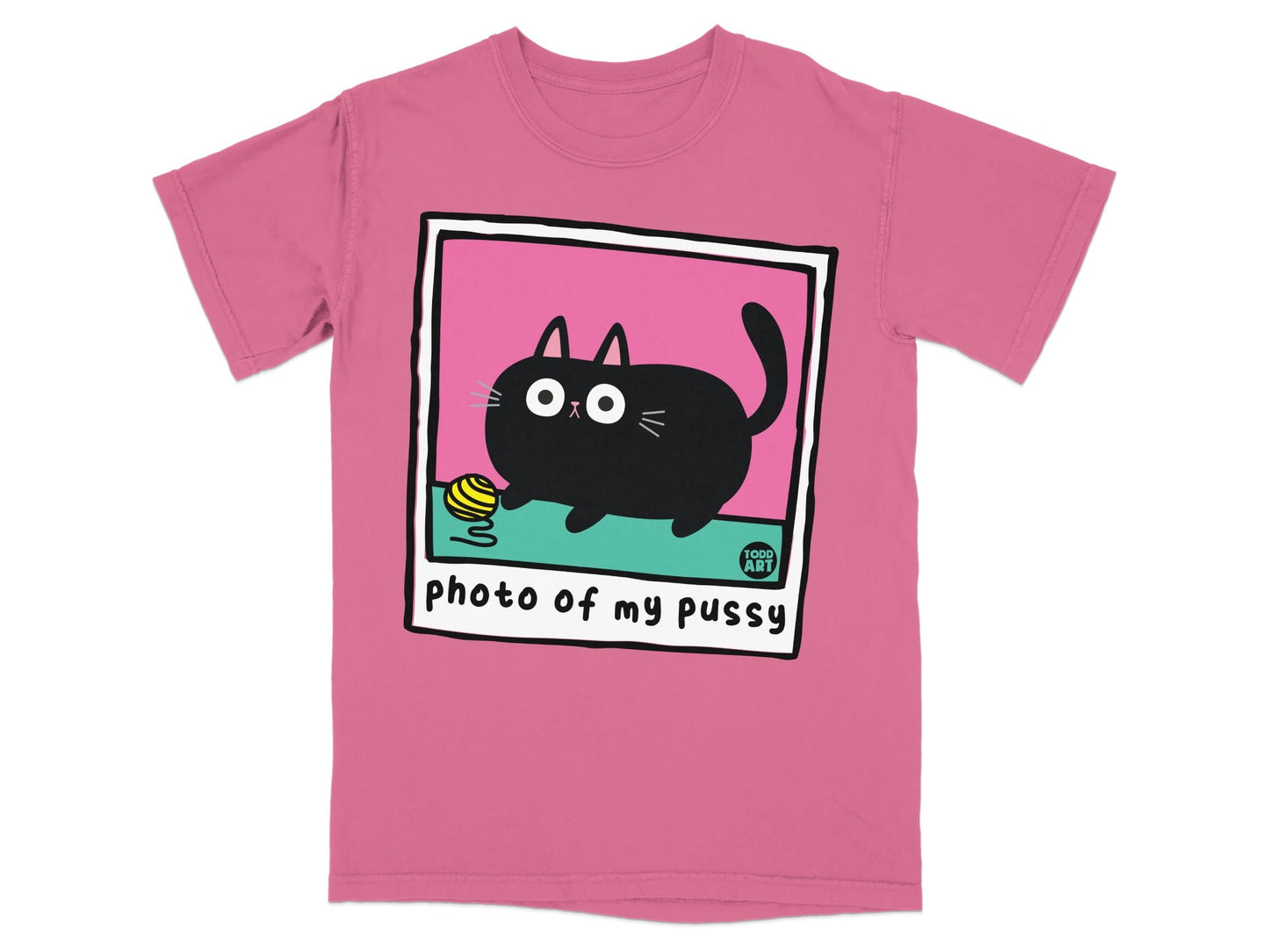 Pink t-shirt with a cartoon black cat playing with yarn in a polaroid frame.