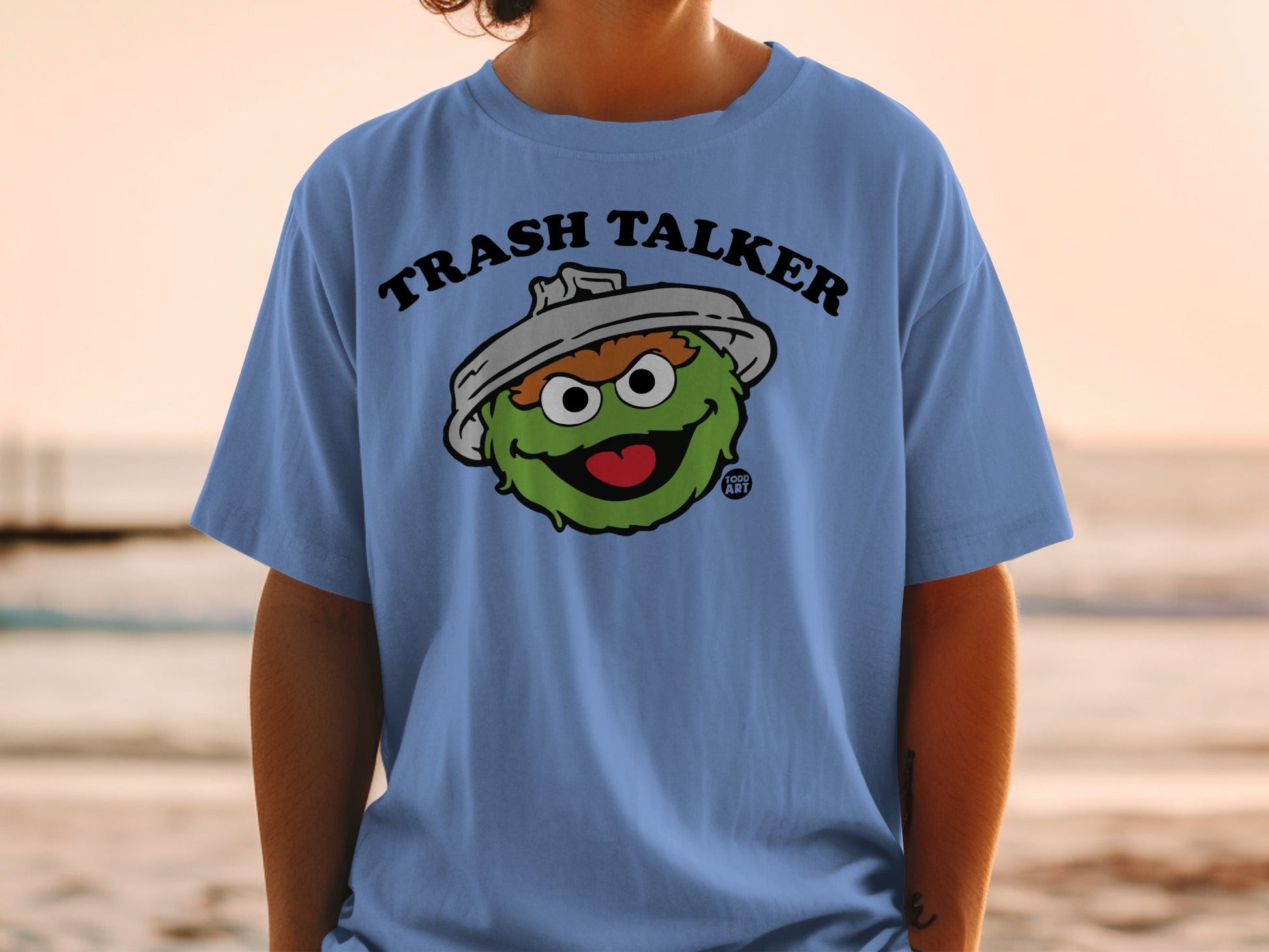 Light blue t-shirt with "Trash Talker" and cartoon Oscar the Grouch.