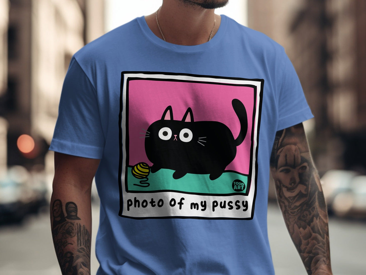 Black cat with yarn ball on pink and green background, text "PHOTO of my pussy".