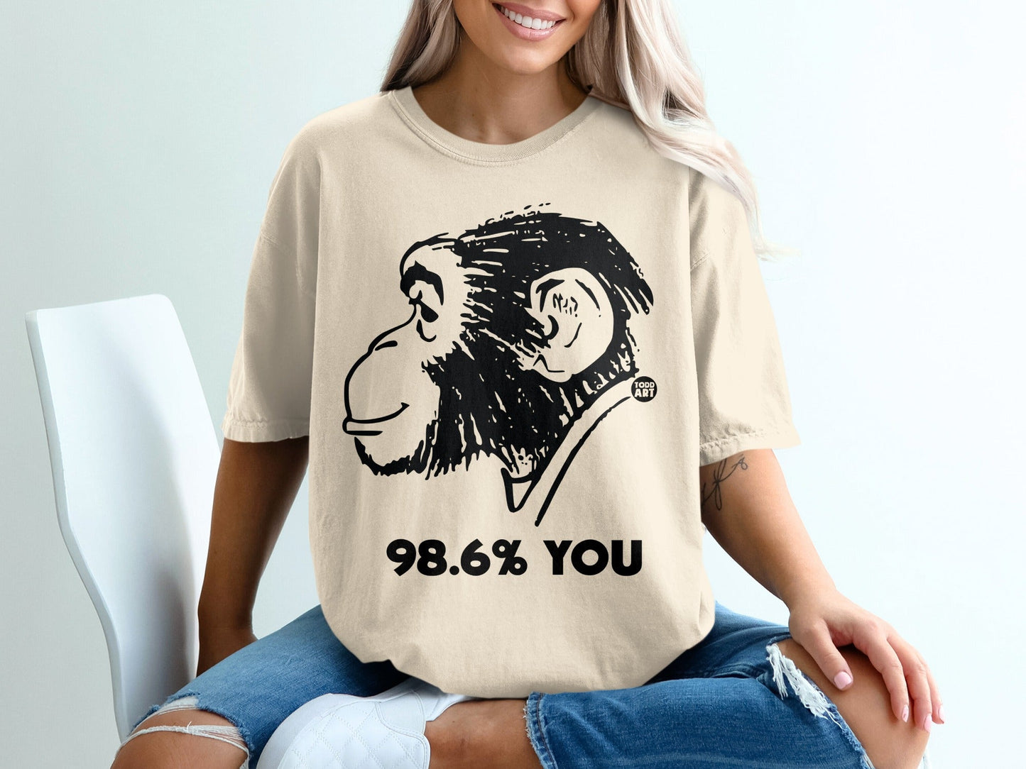 T-shirt with a black line drawing of a chimpanzee and text "98.6% YOU".