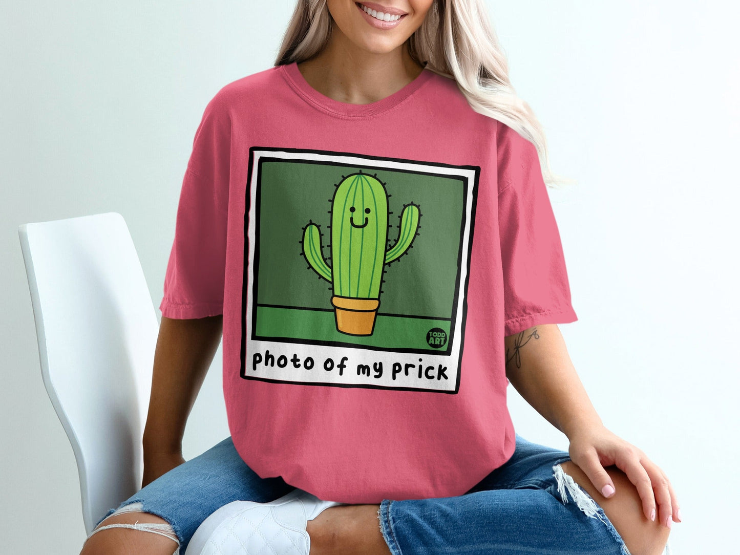 Pink t-shirt with a cartoon cactus and "photo of my prick" text.