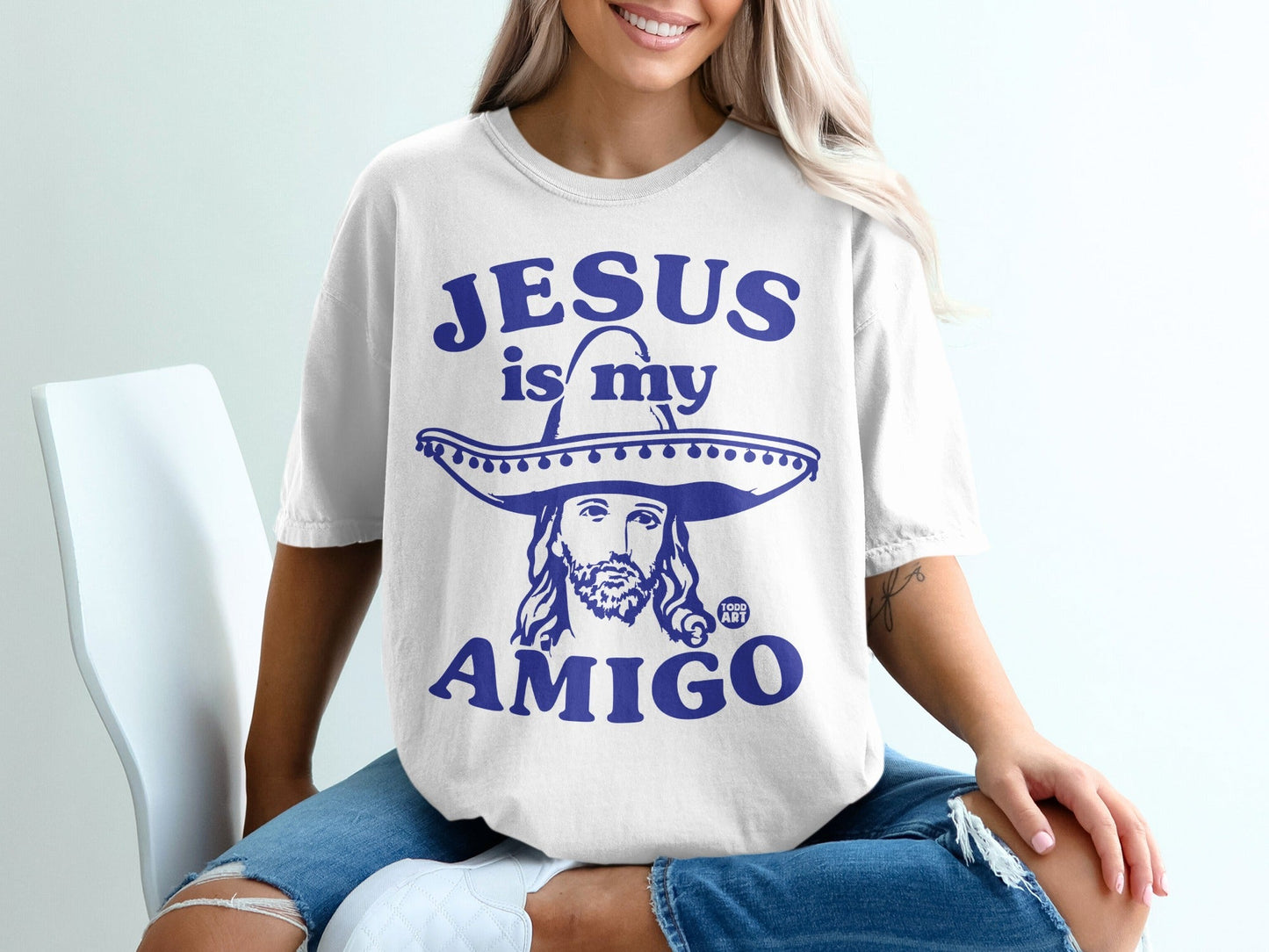 White t-shirt with "JESUS IS MY AMIGO" and Jesus wearing a sombrero.