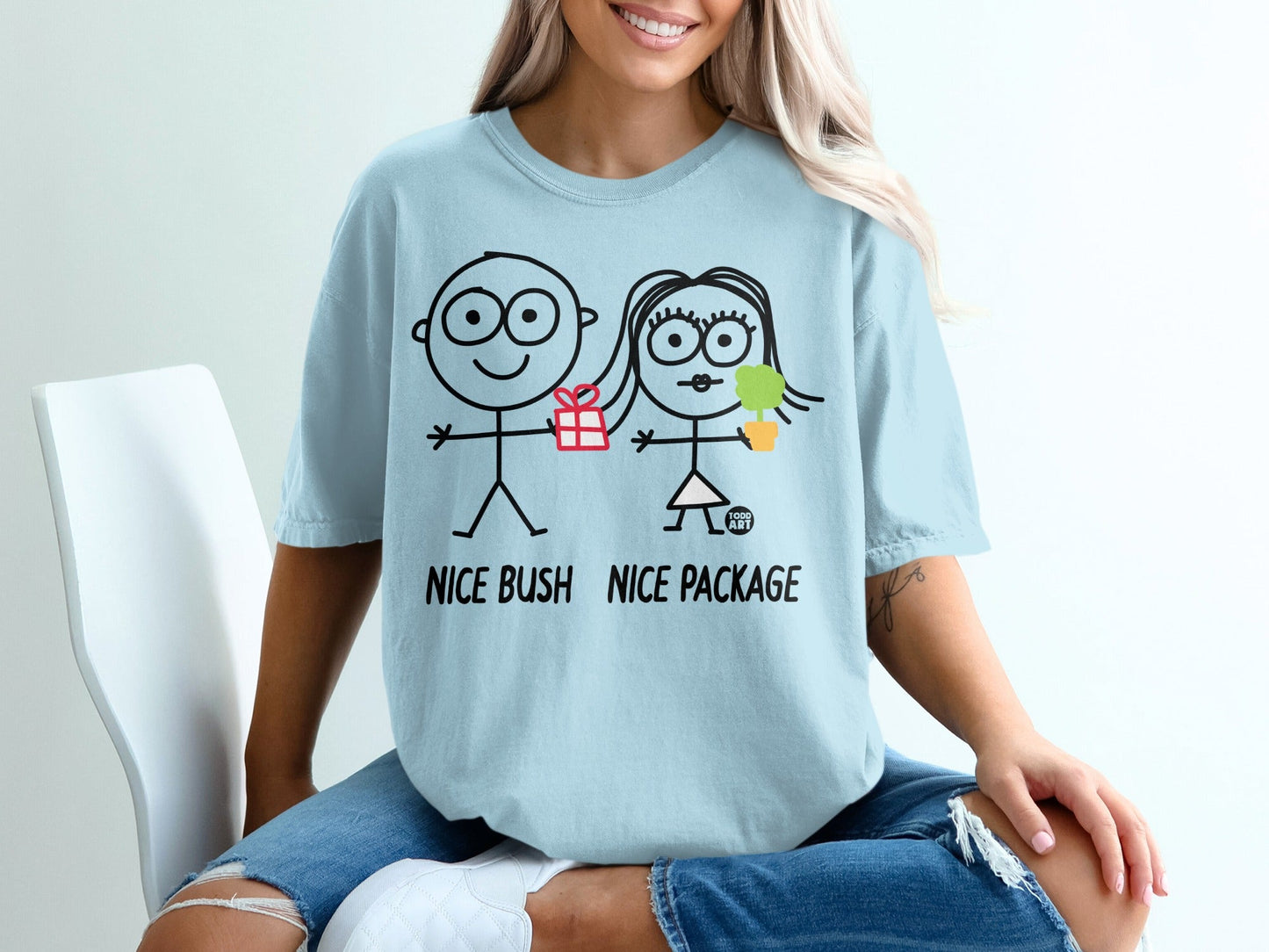 Light blue t-shirt with stick figures and text "NICE BUSH NICE PACKAGE".