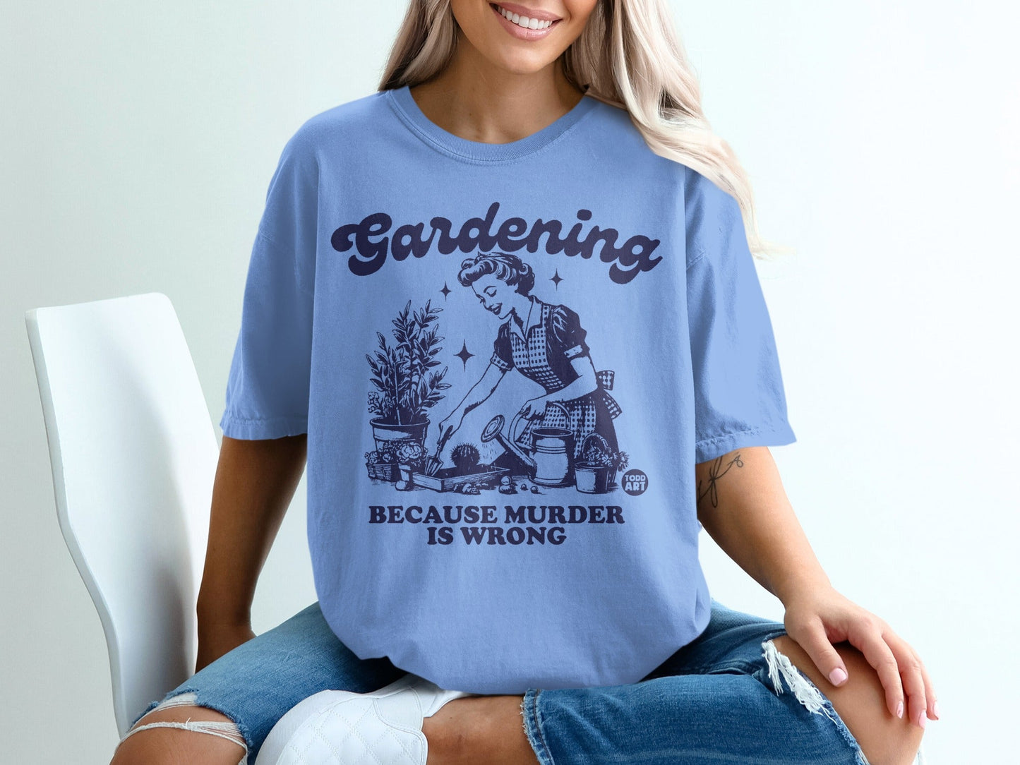 Light blue t-shirt with "Gardening Because Murder Is Wrong" text and vintage illustration.