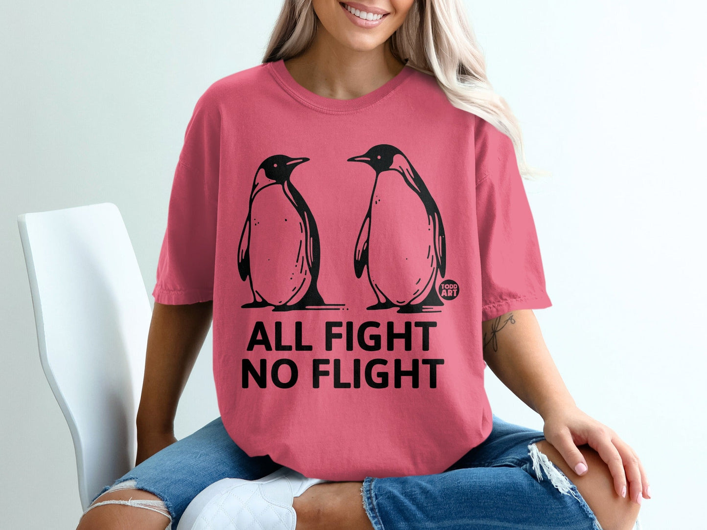 Pink t-shirt with "ALL FIGHT NO FLIGHT" text and two penguins.