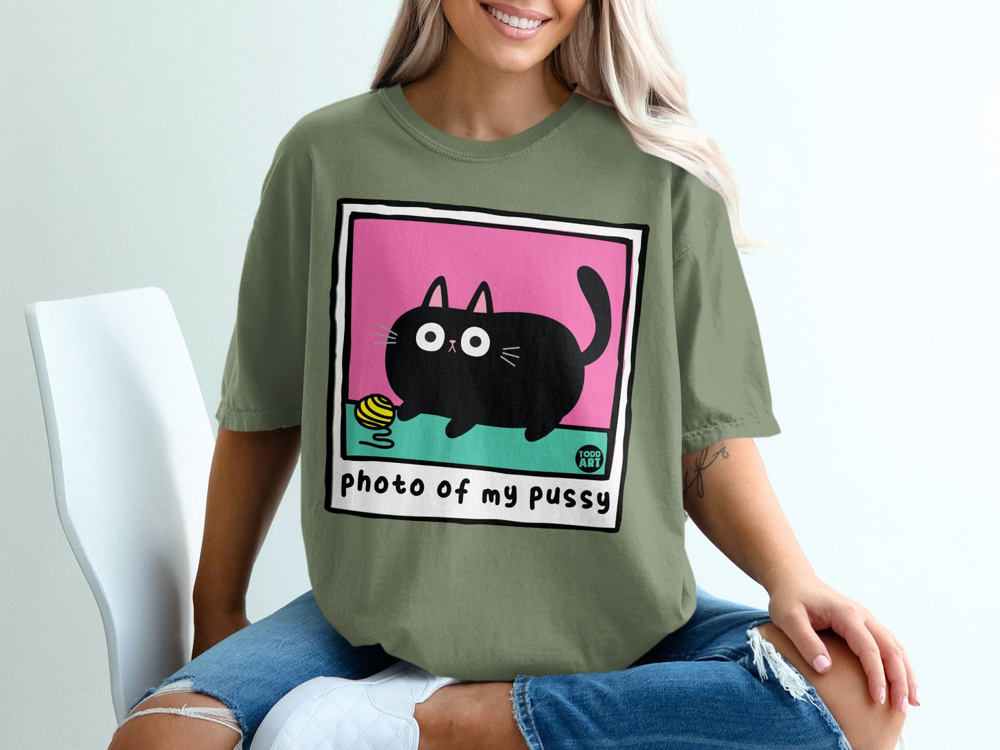 Black cat with yarn ball on pink background, t-shirt design