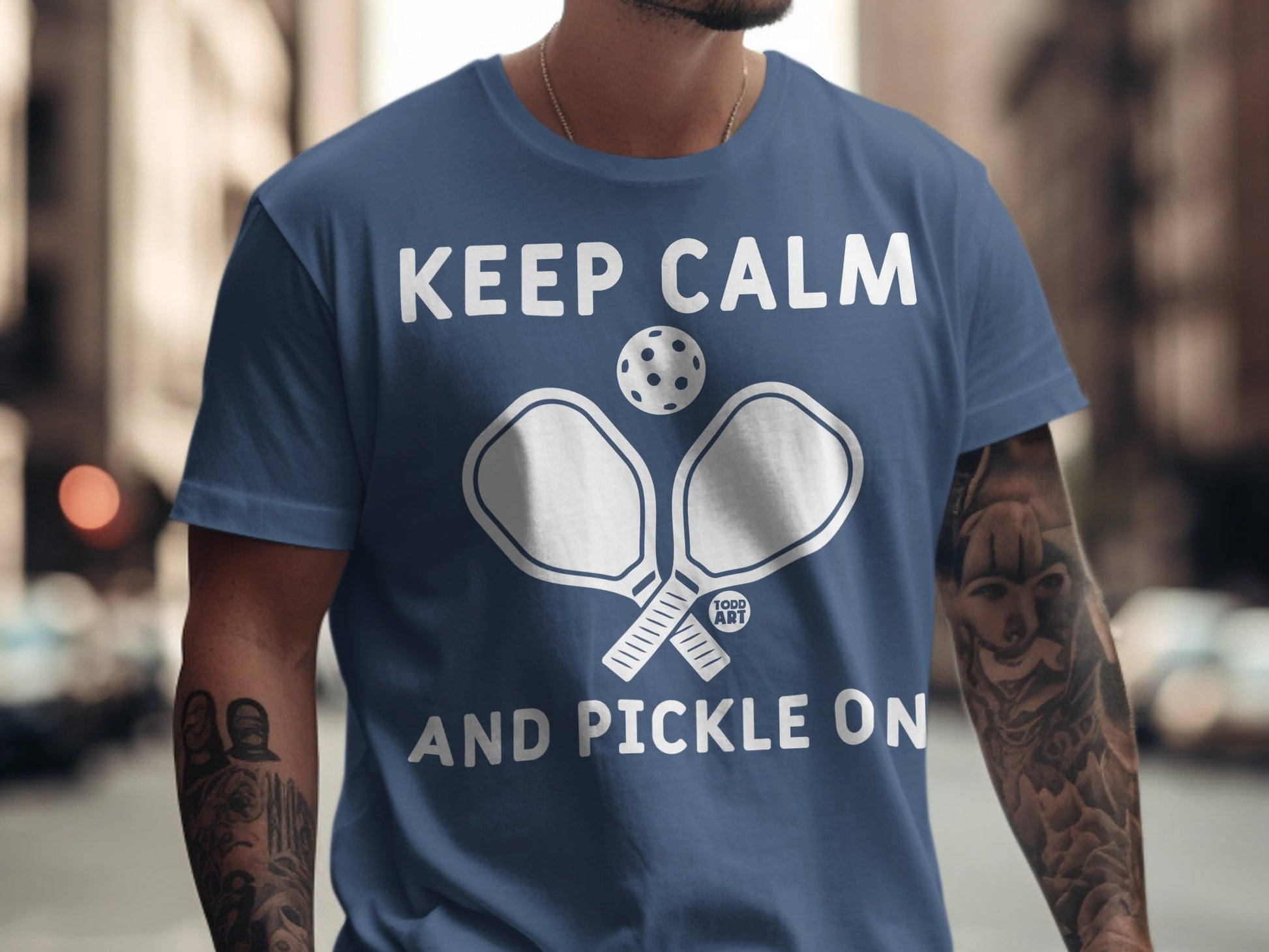 Dark blue t-shirt with "Keep Calm and Pickle On" and pickleball graphic.