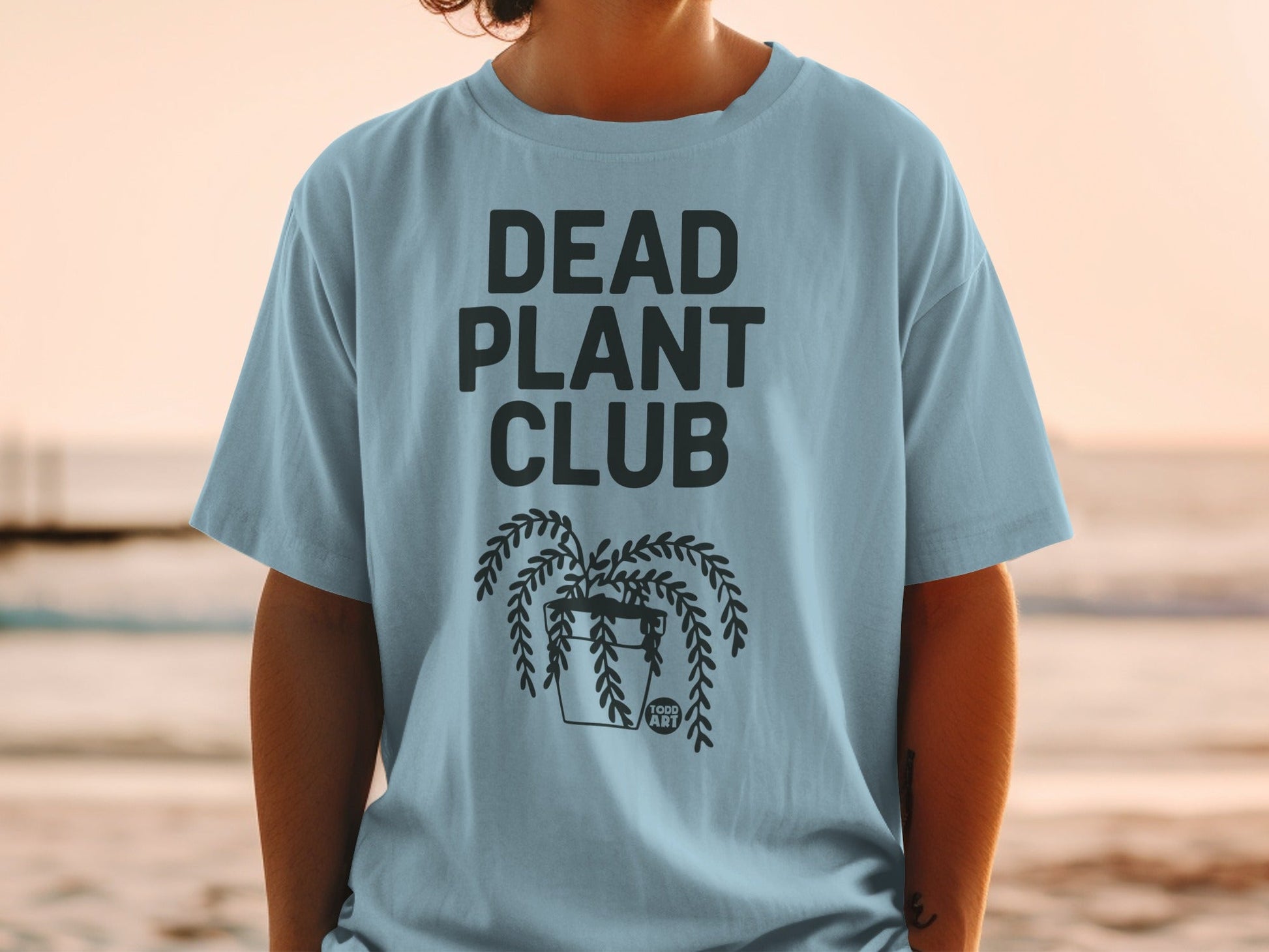 Light blue t-shirt with "DEAD PLANT CLUB" and a hanging plant graphic.