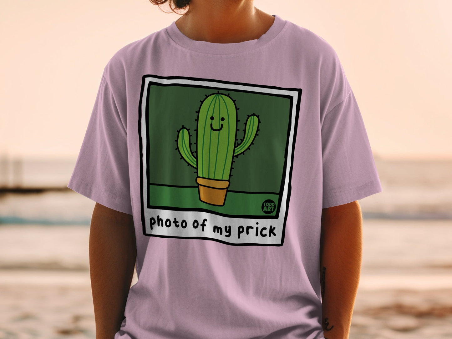 Pink t-shirt with a cartoon cactus in a pot, text "photo of my prick".