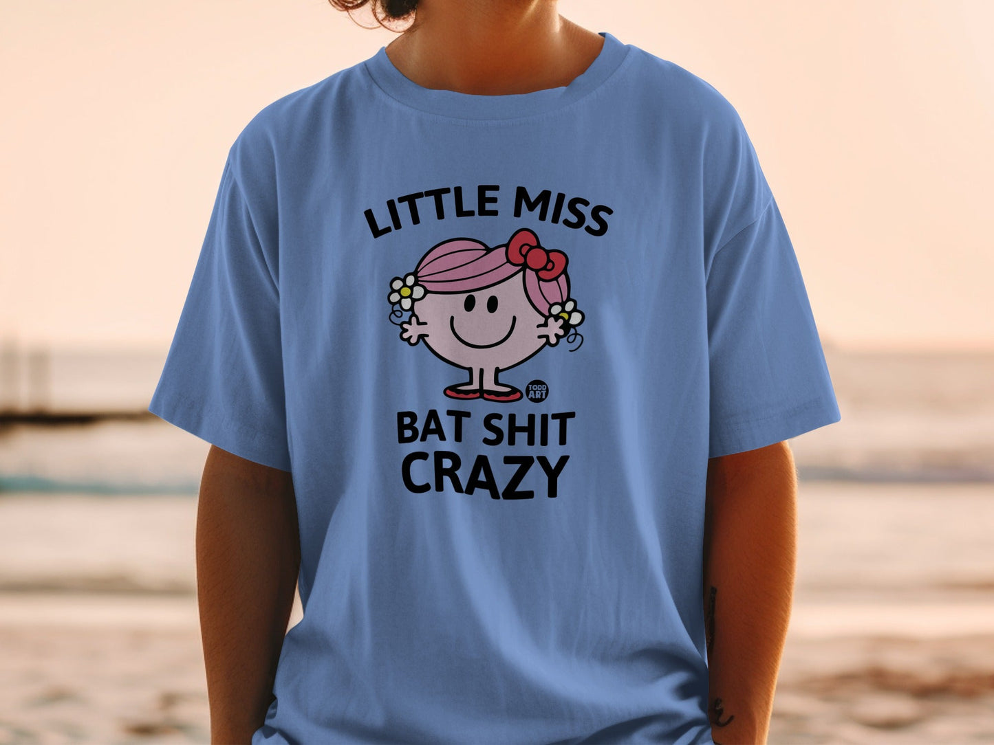 Light blue t-shirt with "Little Miss Bat Shit Crazy" text and character.