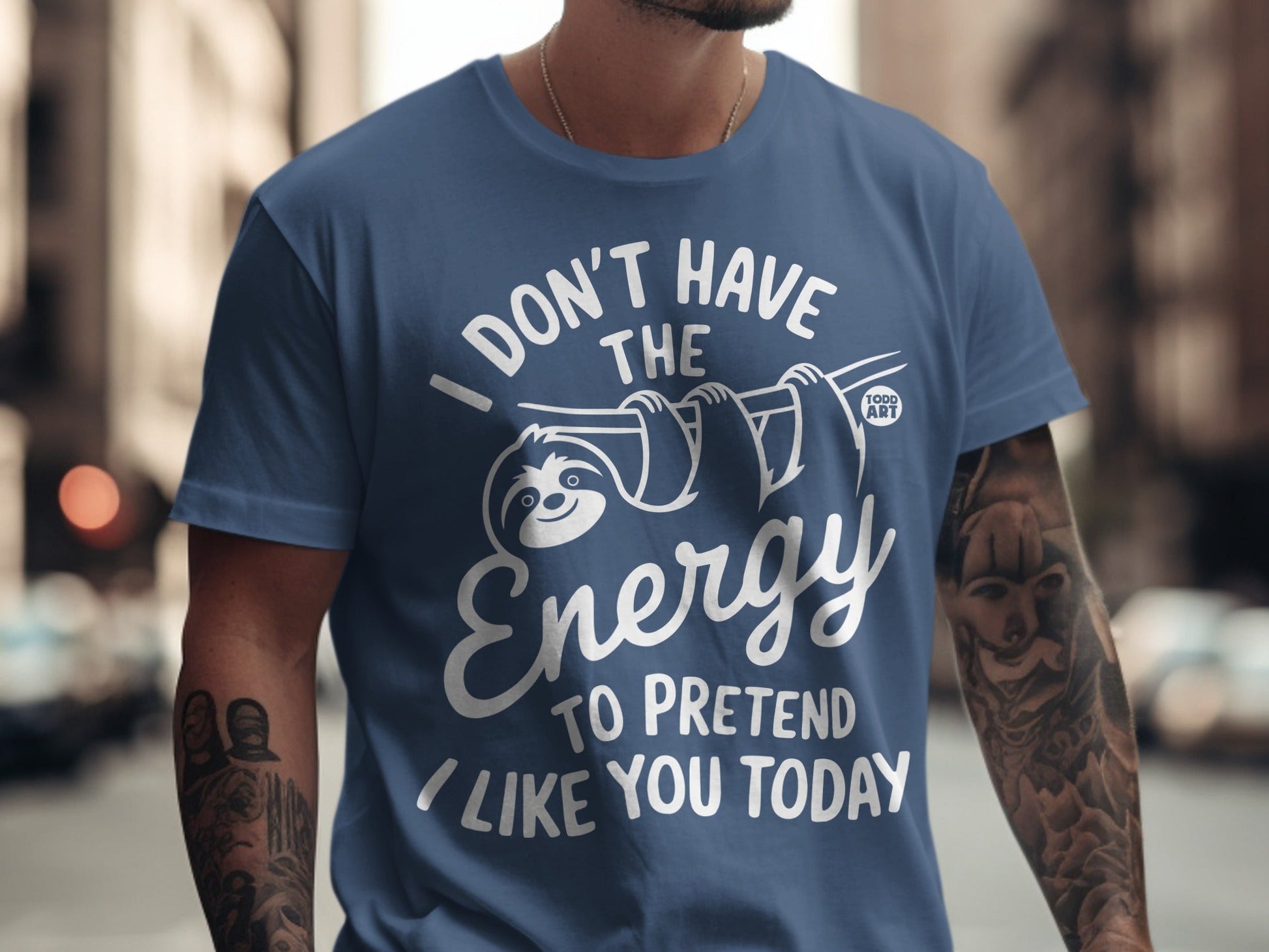 Blue t-shirt with white text and sloth graphic: "I don't have the energy to pretend I like you today".