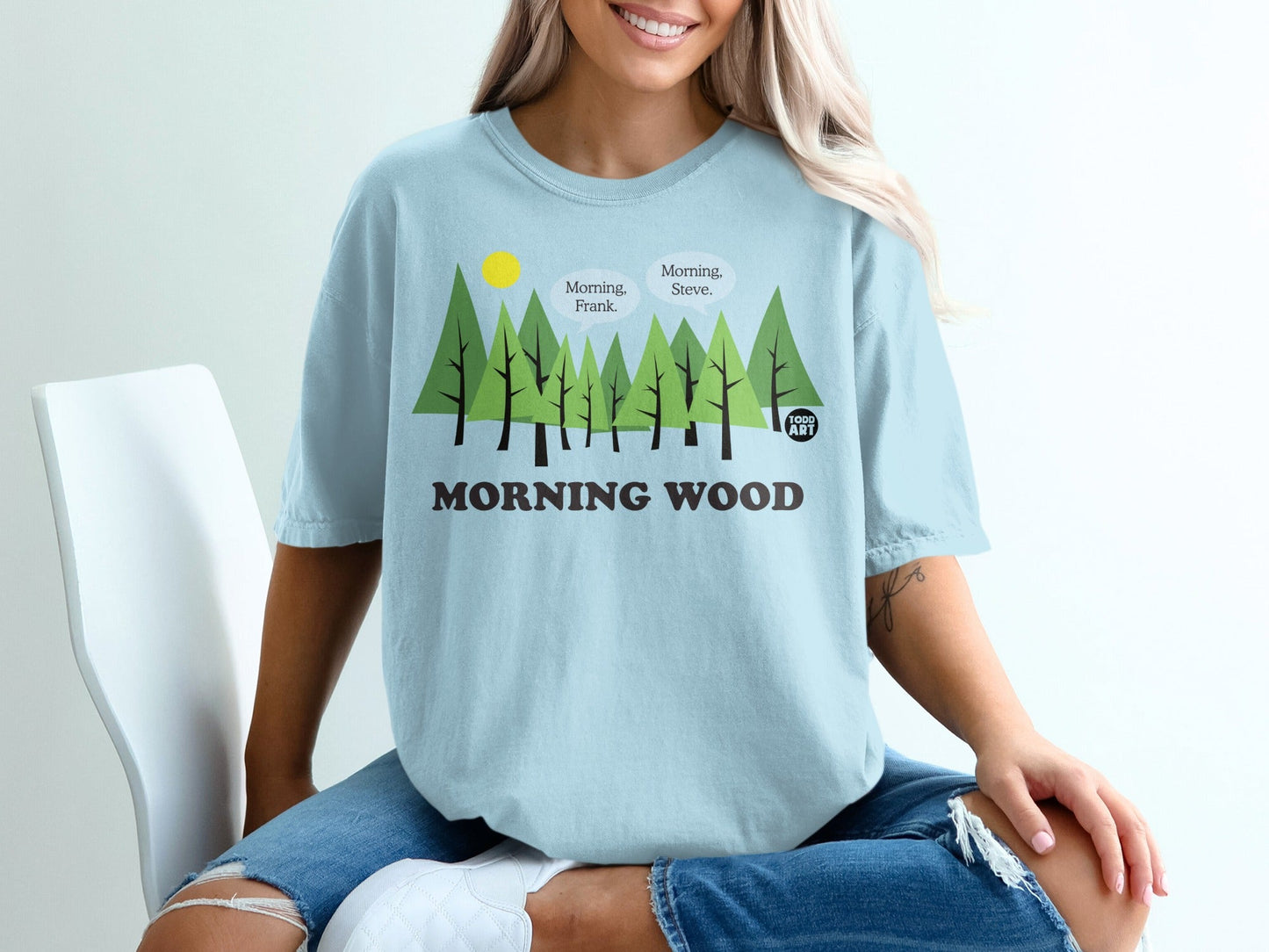 Light blue t-shirt with cartoon trees and "Morning Wood" text.