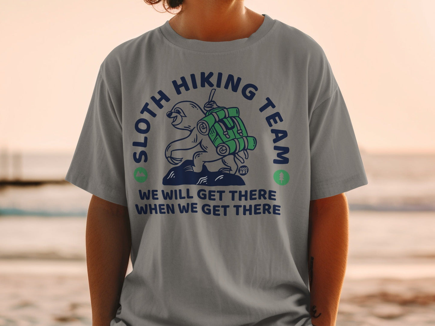 Sloth hiking team graphic with a sloth carrying a backpack on a t-shirt.