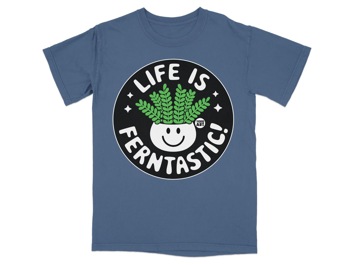 Blue t-shirt with a circular graphic featuring a smiling plant in a pot and text "LIFE IS FERNTASITC!".