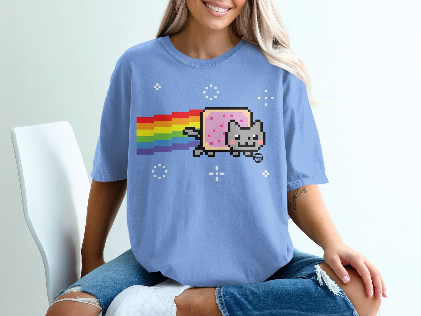 Light blue t-shirt with Nyan Cat and rainbow pixel art graphic.