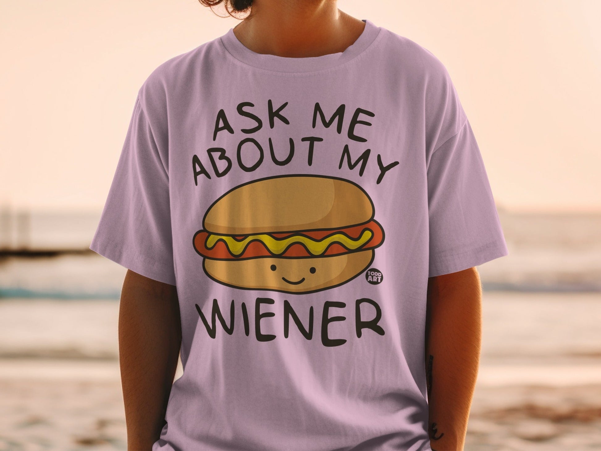 T-shirt with text "Ask Me About My Wiener" and hot dog graphic.