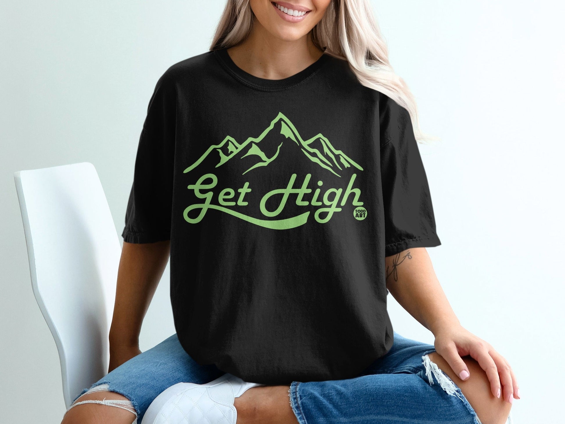 Black t-shirt with "Get High 100% ART" and mountain graphic.
