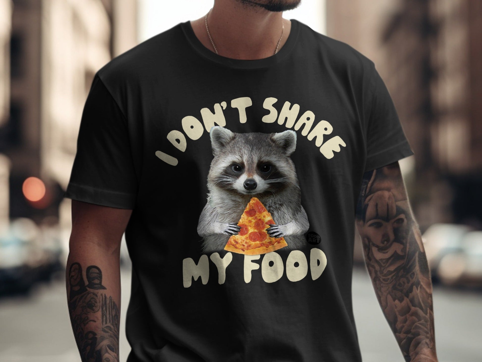 Black t-shirt with raccoon holding pizza slice and text "I don't share my food."