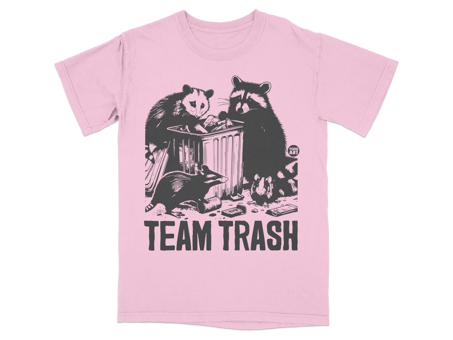 Raccoons and opossum dumpster diving on a pink t-shirt with "TEAM TRASH" text.